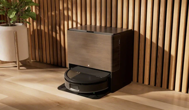Roomba 705 Max Combo sitting against wood wall near plant