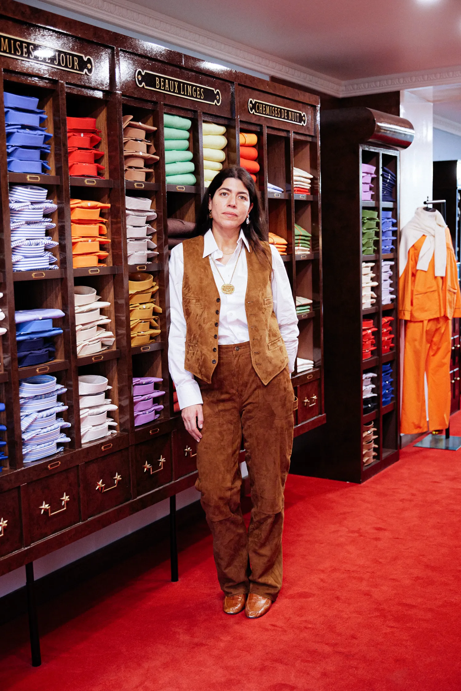 Image may contain Dressing Room Indoors Room Adult Person Clothing Vest Furniture WalkIn Closet Coat and Pants
