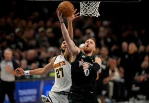 MINNEAPOLIS, MN. - APRIL 2026: Minnesota Timberwolves guard Donte DiVincenzo (0) scores as Denver Nuggets guard Jamal Murray (27) tries to defend in the second quarter. The Minnesota Timberwolves faced the Denver Nuggets in Game 3 of a first-round NBA playoffs basketball series Thursday, April 23, 2026 at Target Center in Minneapolis, Minn. (Photo by Jeff Wheeler/The Minnesota Star Tribune via Getty Images)