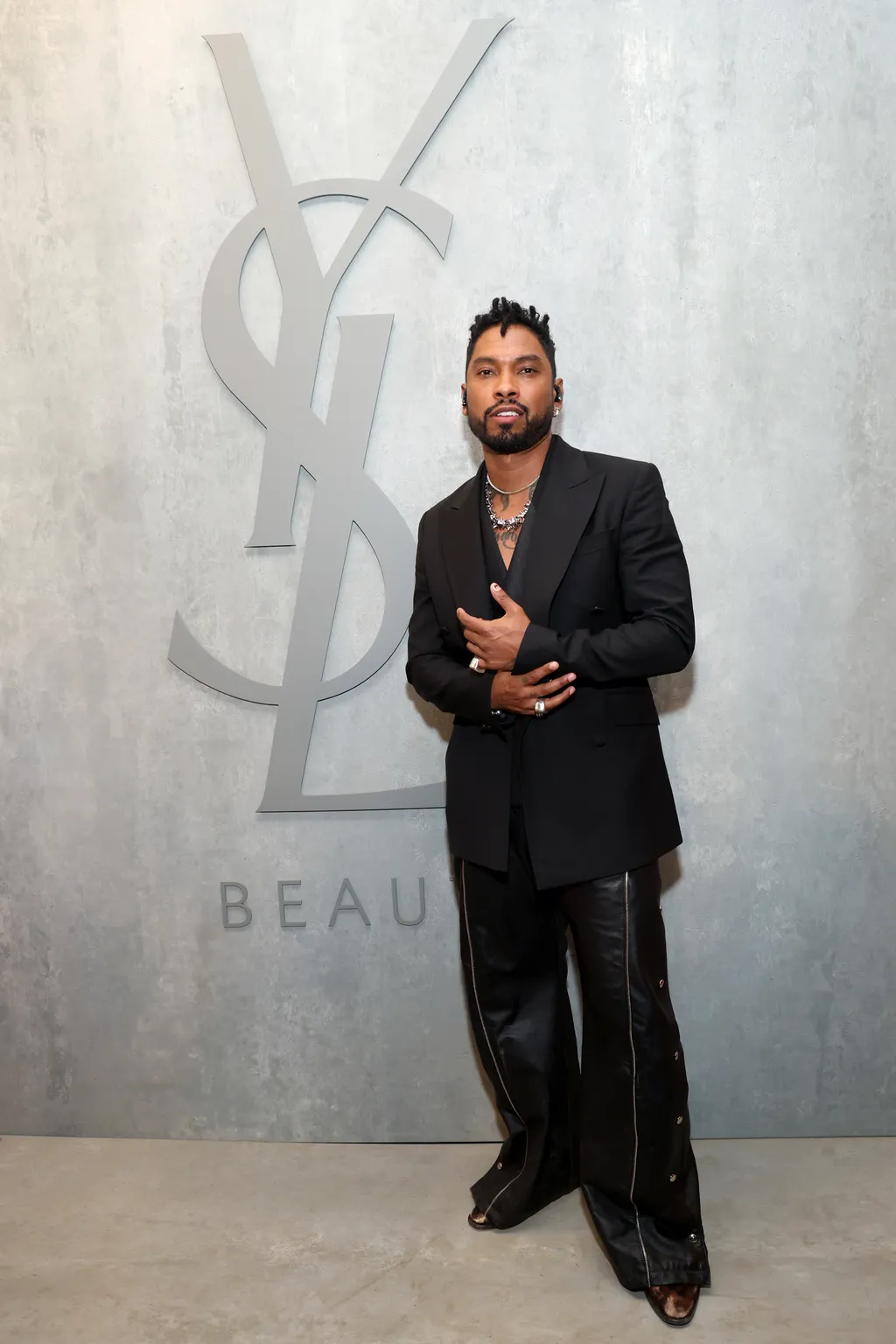 Image may contain Miguel Blazer Clothing Coat Jacket Person Standing Adult Formal Wear and Suit