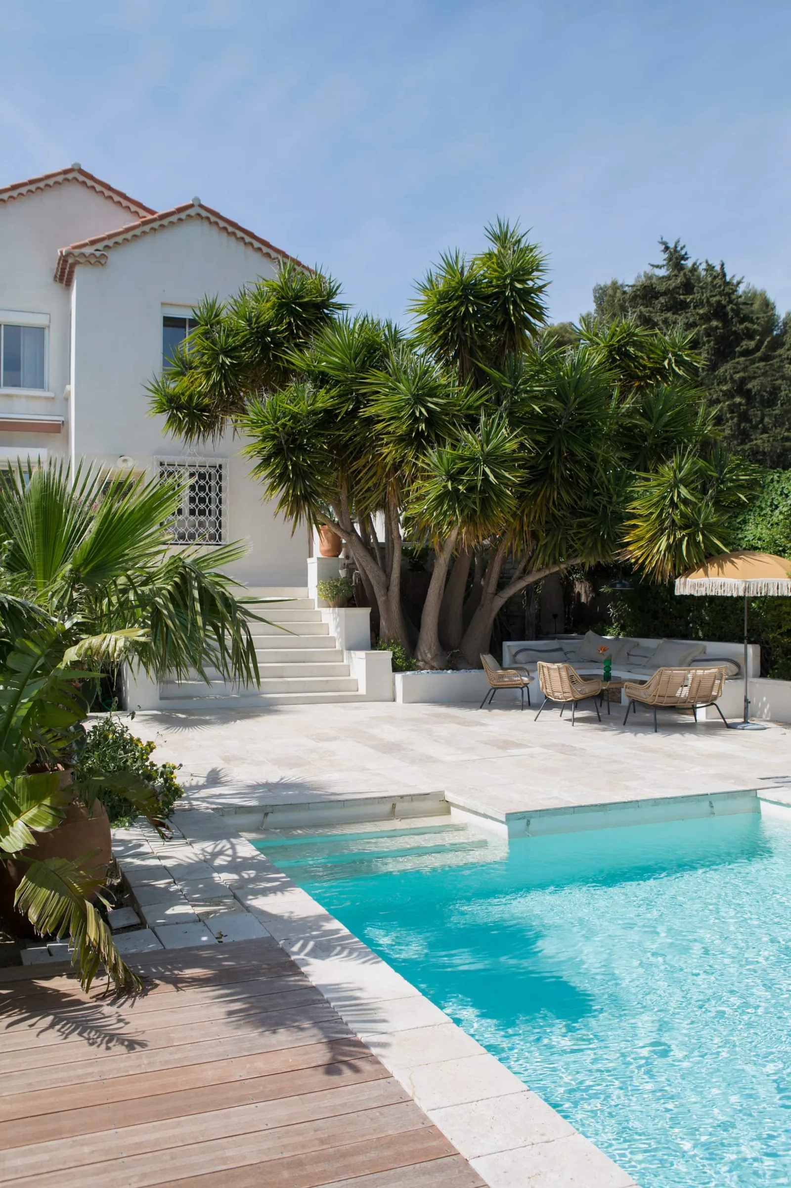 Image may contain Architecture Building House Housing Villa Pool Water Swimming Pool Chair Furniture and Backyard