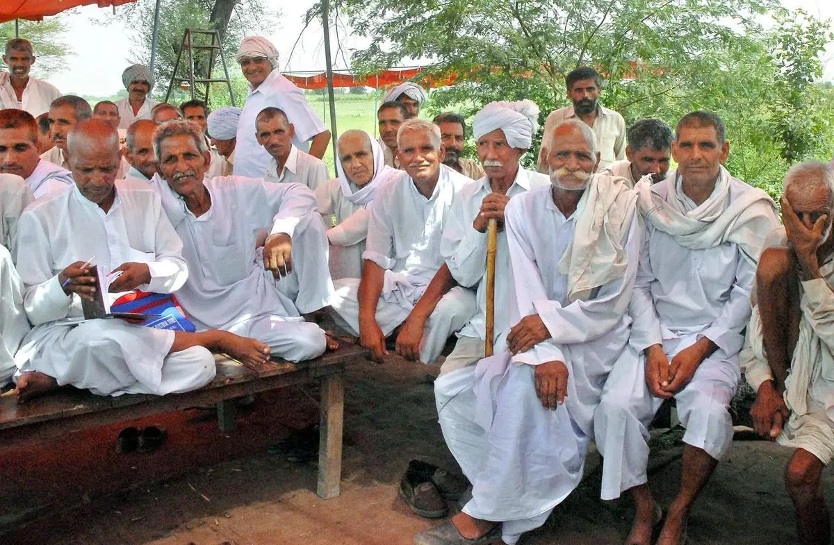 Members of a “khap panchayat” demanding the expulsion of a family who they claim violated gotra norms, in Dharana village, Jhajjar district, Haryana, on August 3, 2009.