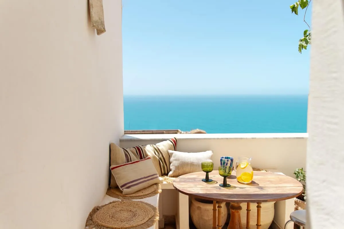 Image may contain Architecture Balcony Building Desk Furniture and Table