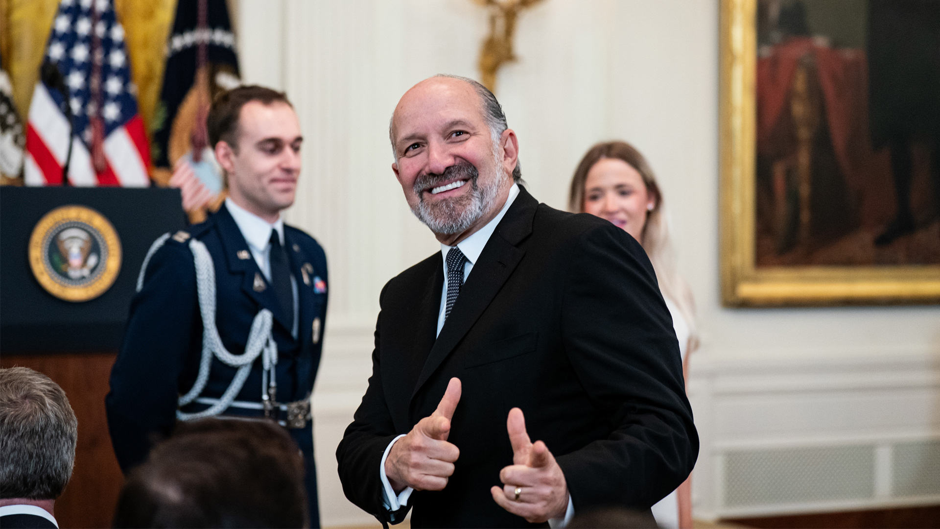 Howard Lutnick giving the double finger gun gesture.