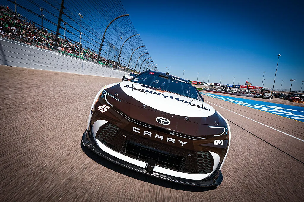 KANSAS CITY, KANSAS - APRIL 19: Tyler Reddick, driver of the #45 SupplyHouse Toyota and Denny Hamlin, driver of the #11 National Debt Relief Toyota lead the field before the NASCAR Cup Series AdventHealth 400 at Kansas Speedway on April 19, 2026 in Kansas City, Kansas. (Photo by David Jensen/Getty Images)