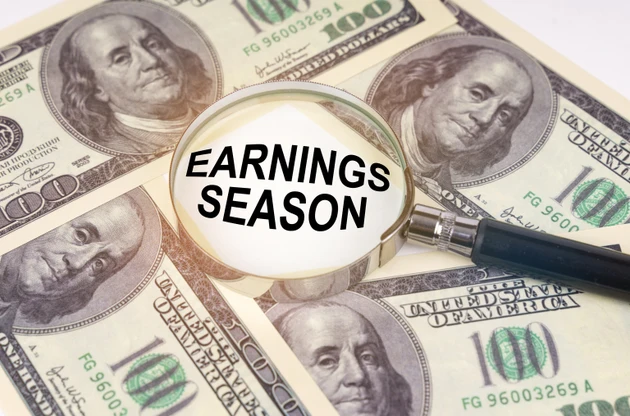 Among the dollars lies a magnifying glass with the inscription - Earnings Season