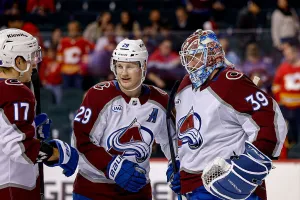 CALGARY, CANADA- APRIL 14: Nathan MacKinnon #29 and Mackenzie Blackwood #39 of the Colorado Avalanche celebrate with teammates after a win against the Calgary Flames at Scotiabank Saddledome on April 14, 2026 in Calgary, Alberta, Canada. (Photo by Jenn Pierce/NHLI via Getty Images)