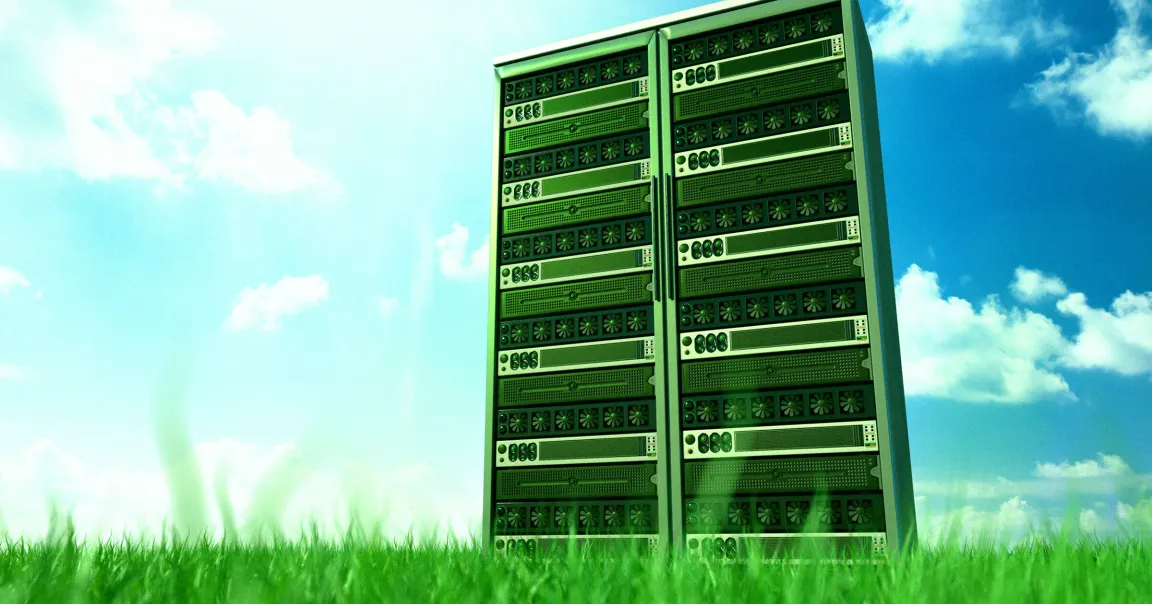 Two tall server racks standing on green grass under a bright blue sky with scattered white clouds. The servers have multiple cooling fans and various ports visible on the front panels.