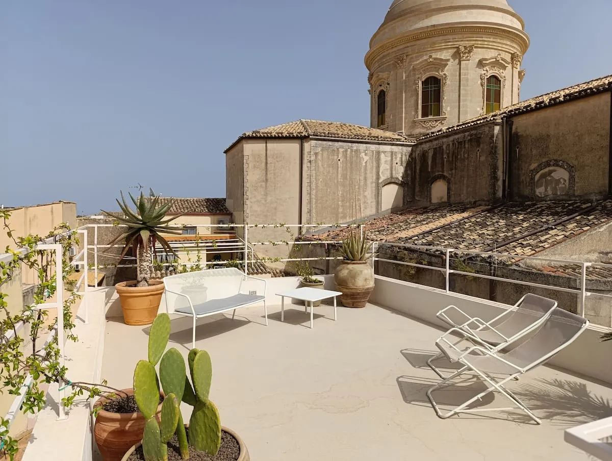 Image may contain Plant Terrace Desk Furniture Table Chair Bench Architecture Building House Housing and Villa