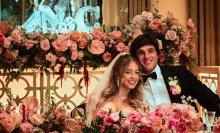 A couple smile at a lavish wedding surrounded by roses in a still from "Euphoria."