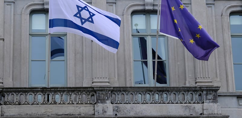 Israeli and EU flags on the European Parliament building in Brussels   credit: Shutterstock
