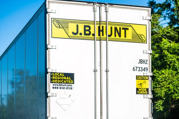 Virginia with yellow logo for JB Hunt cargo transportation truck on interstate highway road and local jobs for drivers