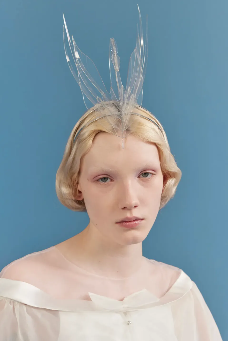 Image may contain Blonde Hair Person Accessories Face Head Photography Swan Headpiece and Portrait