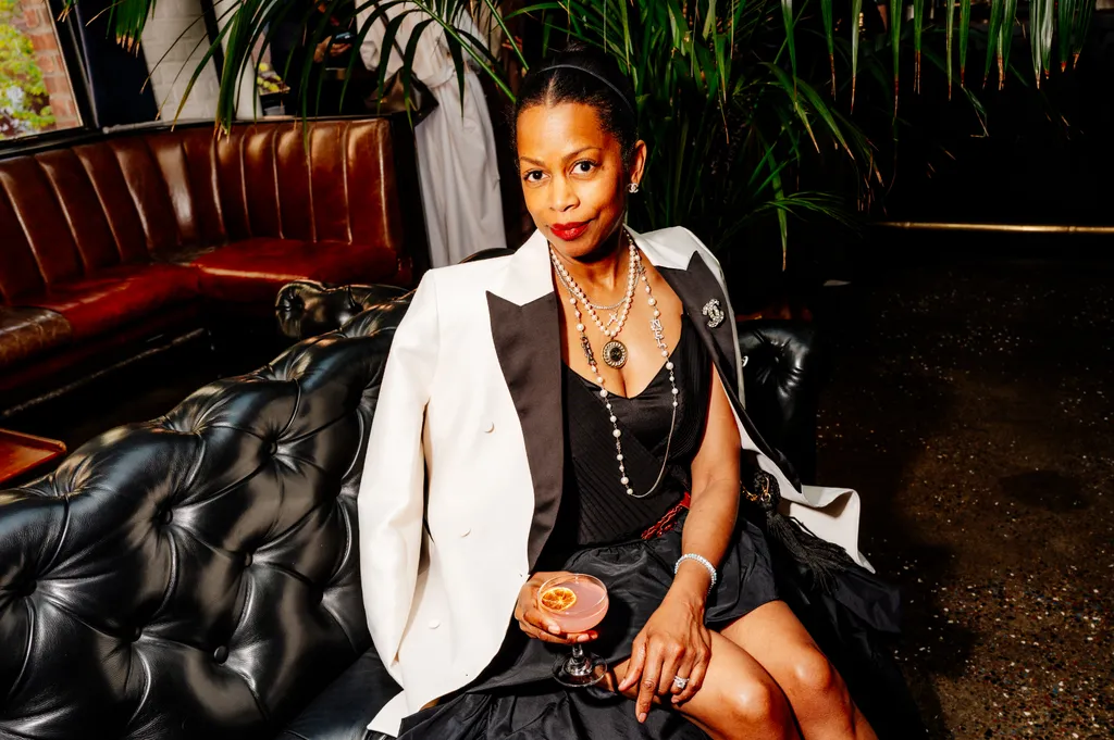 Image may contain Kearran Giovanni Person Sitting Adult Face Head Accessories Jewelry Necklace Dimples and Blazer