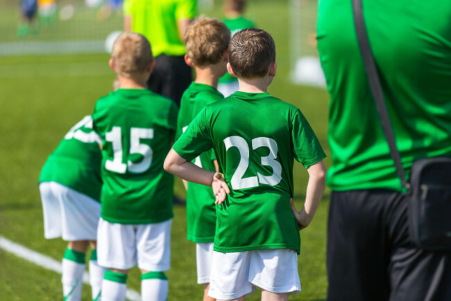 young-boys-and-soccer-coach-watching-football-match-youth-reserve-players-ready-to-play-football-tournament