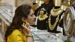 New Delhi: A woman checks gold jewellery on the occasion of Akshaya Tritiya, in New Delhi, Wednesday, April 30, 2025 New Delhi: A woman checks gold jewellery on the occasion of Akshaya Tritiya, in New Delhi, Wednesday, April 30, 2025