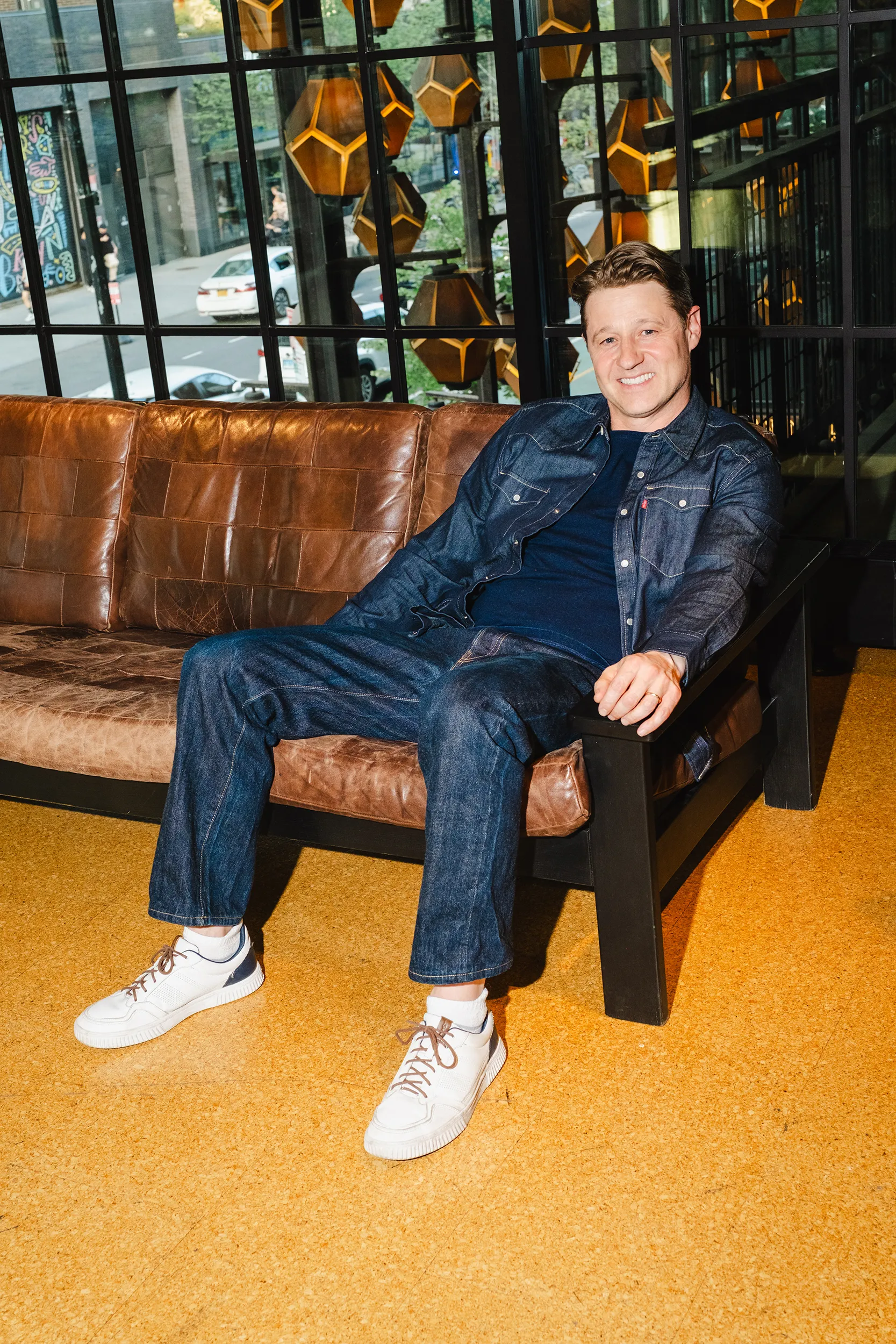 Image may contain Ben McKenzie Person Sitting Clothing Pants Teen Jeans Car Transportation Vehicle Face and Head