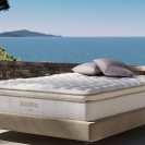 A Saatva mattress sitting on the coast of a European island.