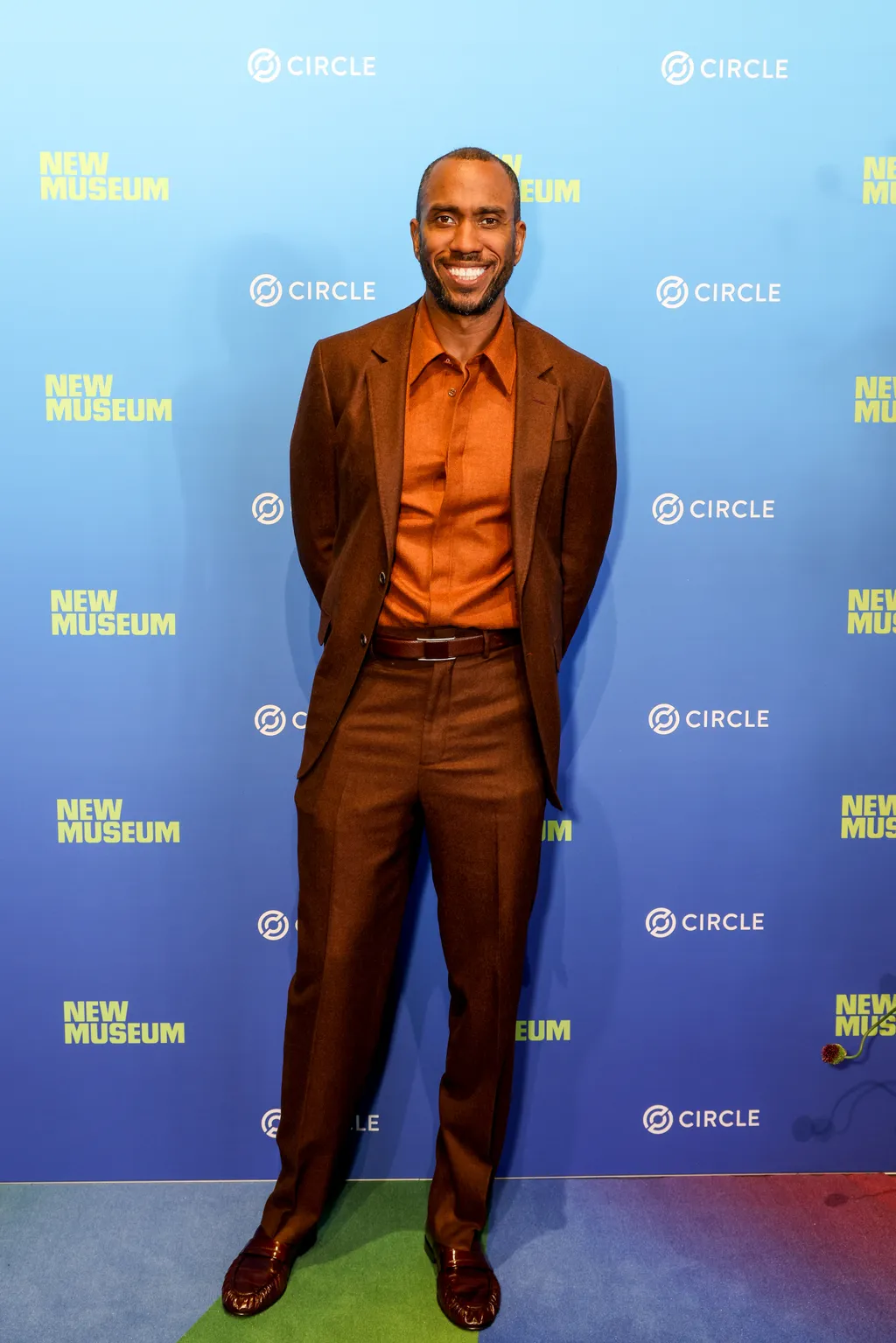 Image may contain Rashid Johnson Clothing Formal Wear Suit Blazer Coat Jacket Person Standing Fashion and Adult