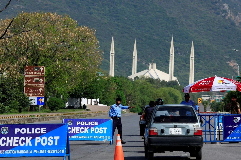 A police officer gestures to a vehicle at a check post near Faisal Masjid on Sunday, as Pakistan attempts to convene a tentative second phase of peace talks between the US and Iran in Islamabad. Photo: Reuters