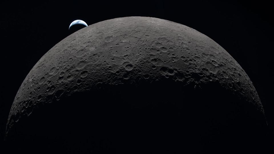 Earth sets from behind the moon.