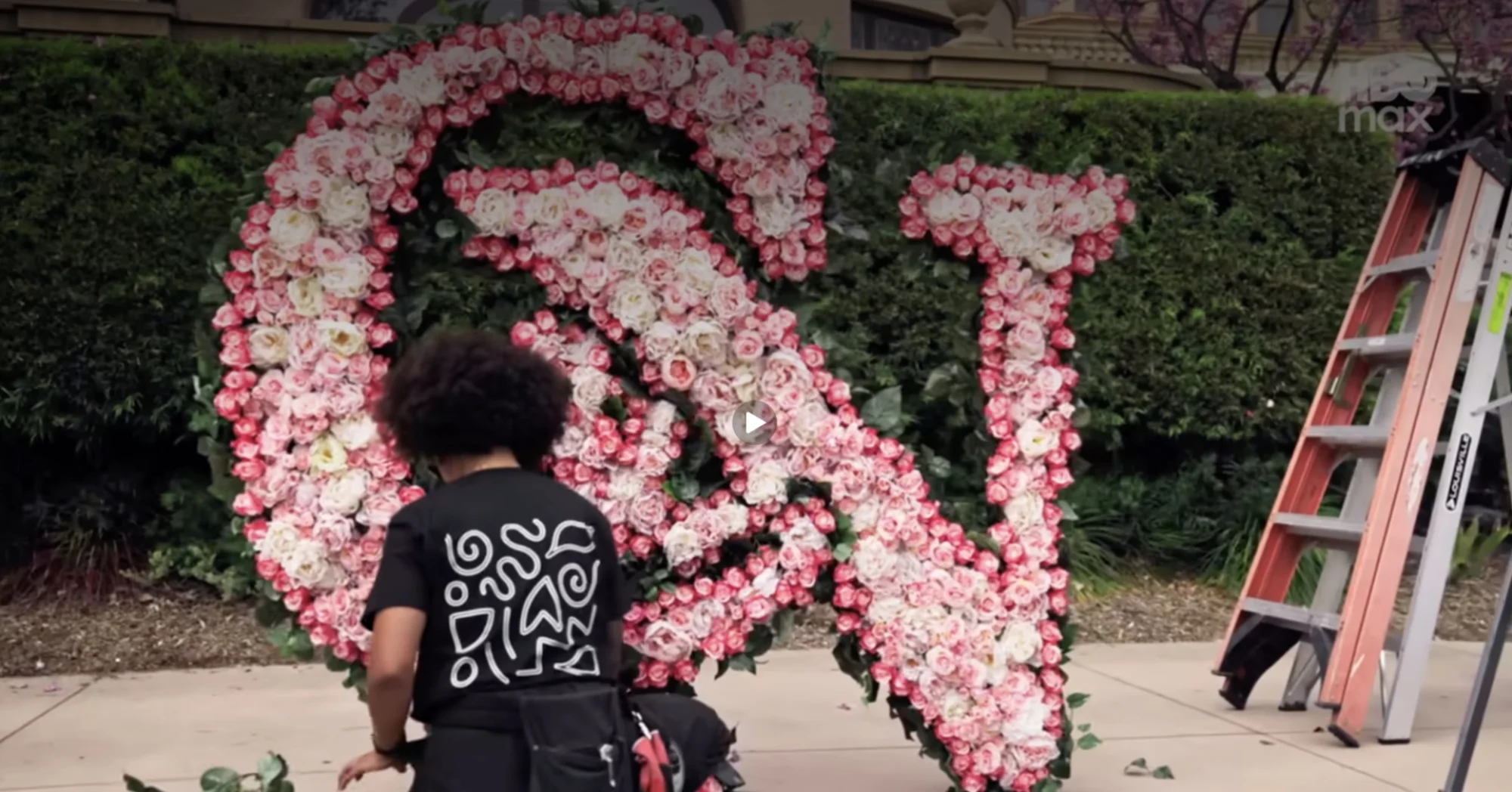 A floral arrangement showing the letters C&N made out of roses.