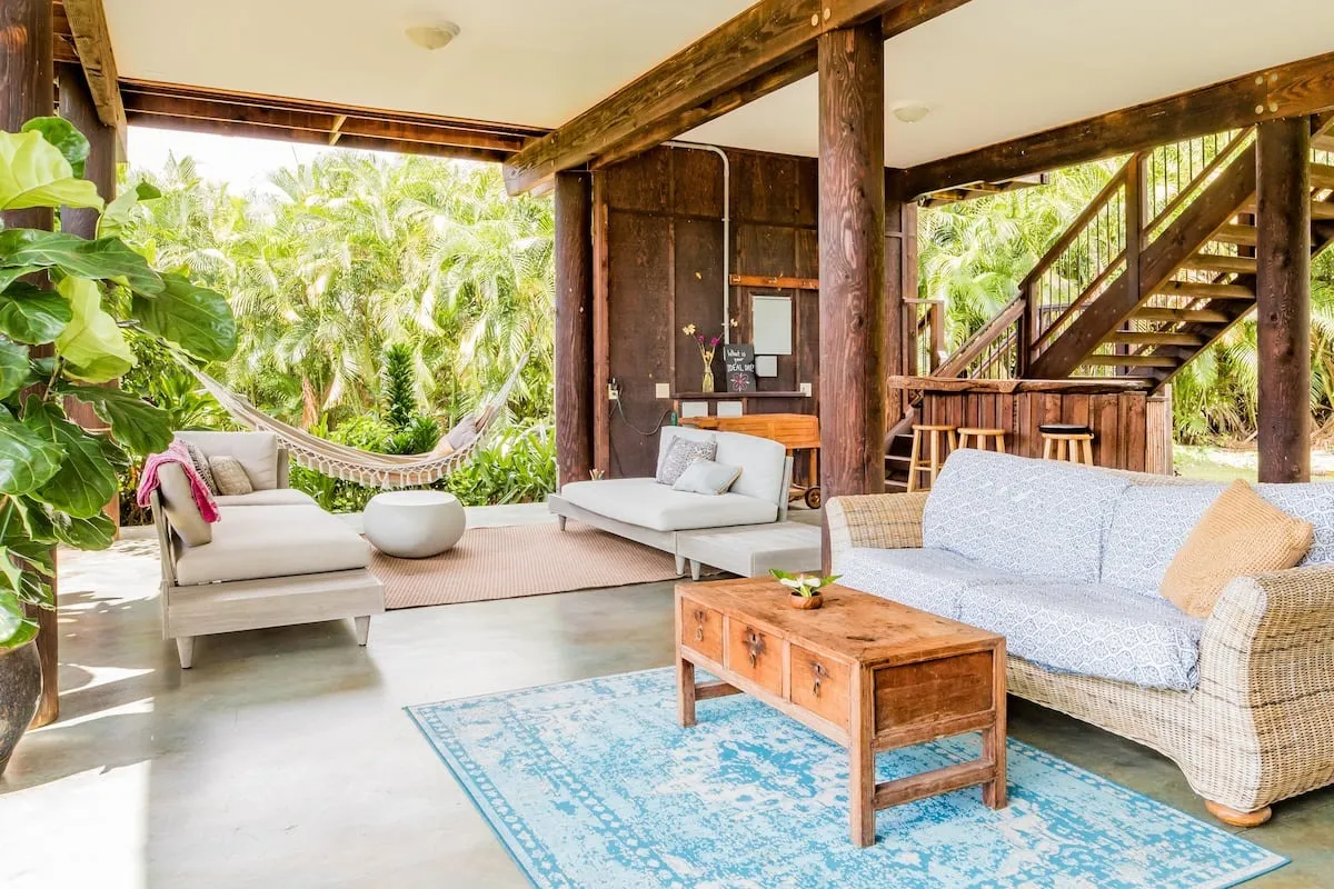 Image may contain Home Decor Couch Furniture Rug Indoors Interior Design Plant Table and Chair