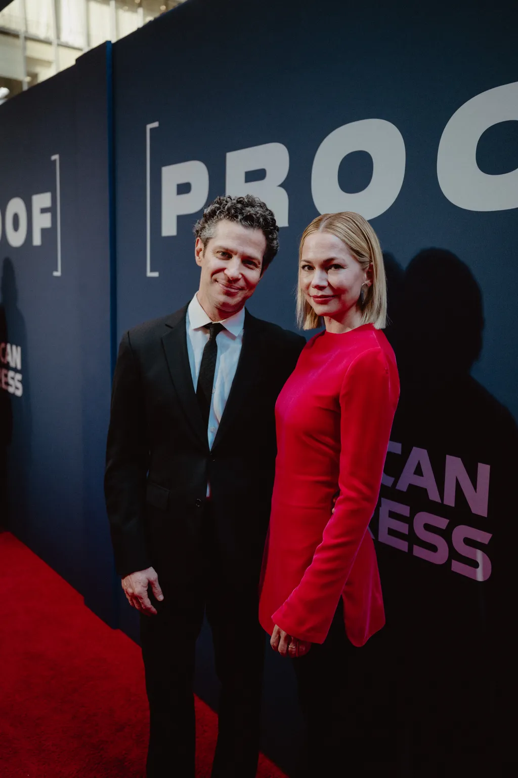 Image may contain Thomas Kail Michelle Williams Fashion Adult Person Photobombing Premiere Face Head and Clothing