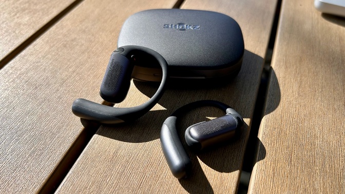 shokz openfit pro earbuds and case on table