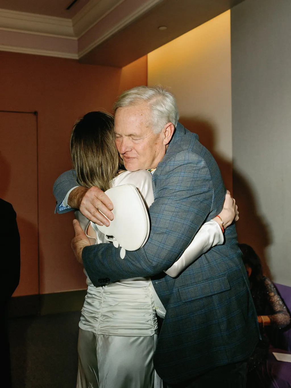 Image may contain Face Head Person Photography Portrait Hugging Blazer Clothing Coat Jacket Glove and Adult