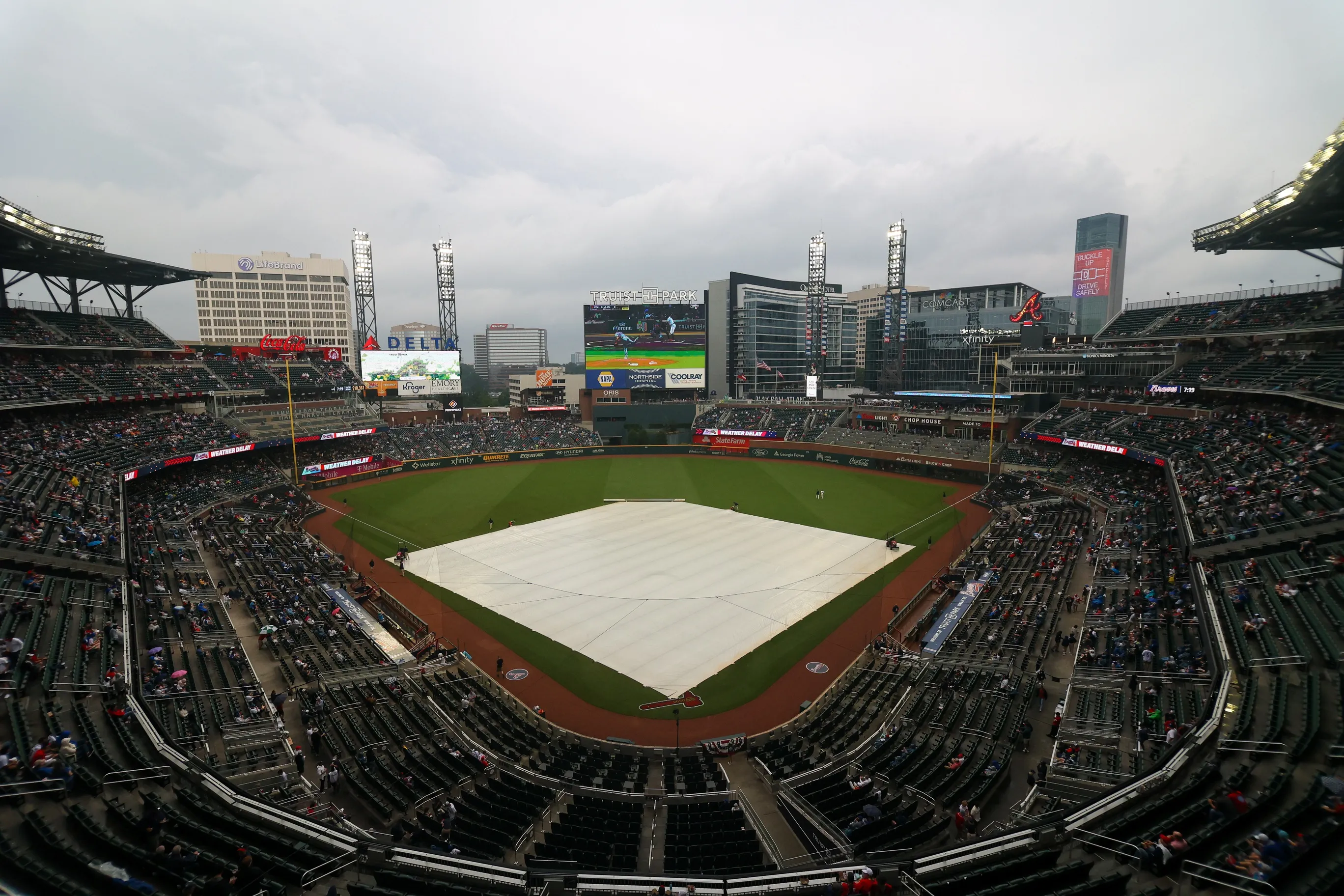 May 22, 2023; Atlanta, Georgia, USA; The tarp covers the field at Truist Park during a rain delay before a game between the Atlanta Braves and Los Angeles Dodgers. Mandatory Credit: Brett Davis-USA TODAY Sports