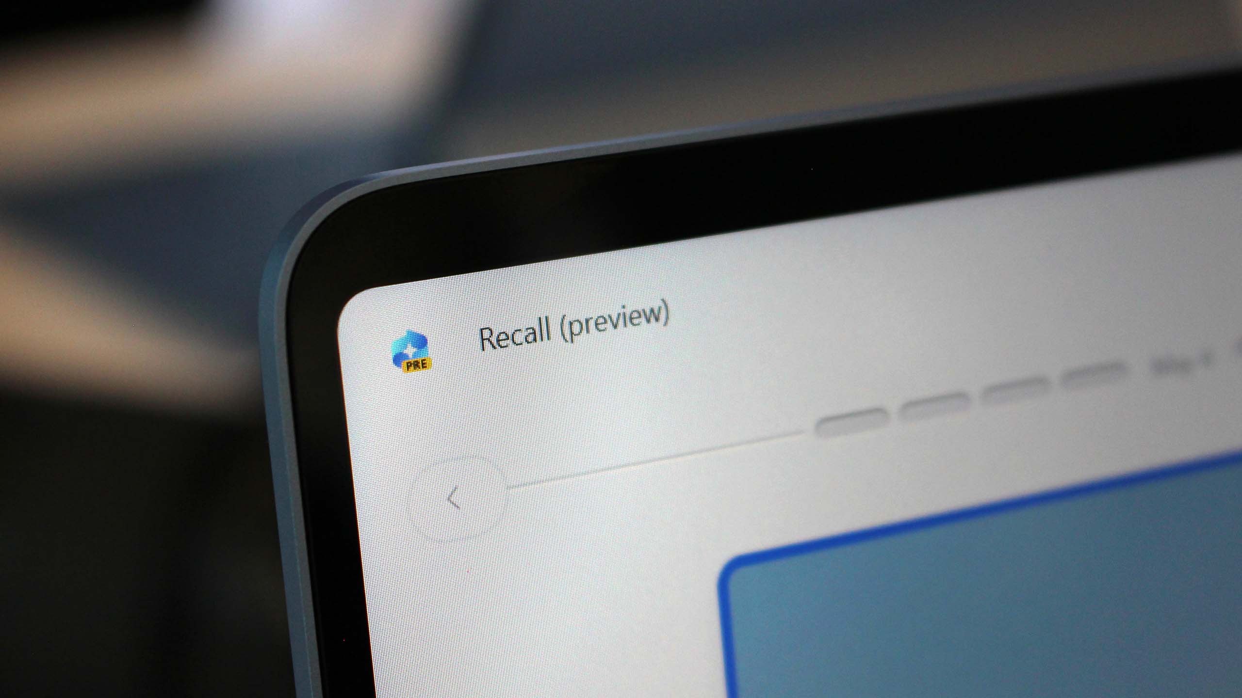 Close-up of a laptop screen showing a software titled "Recall (preview)" in the top corner. The interface is minimal, conveying a sleek, modern design.