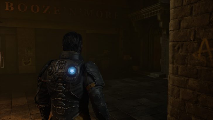 A character in an armored suit with a glowing circular device on their back stands in a dimly lit street near a storefront labeled 'Booze 'N' More'.