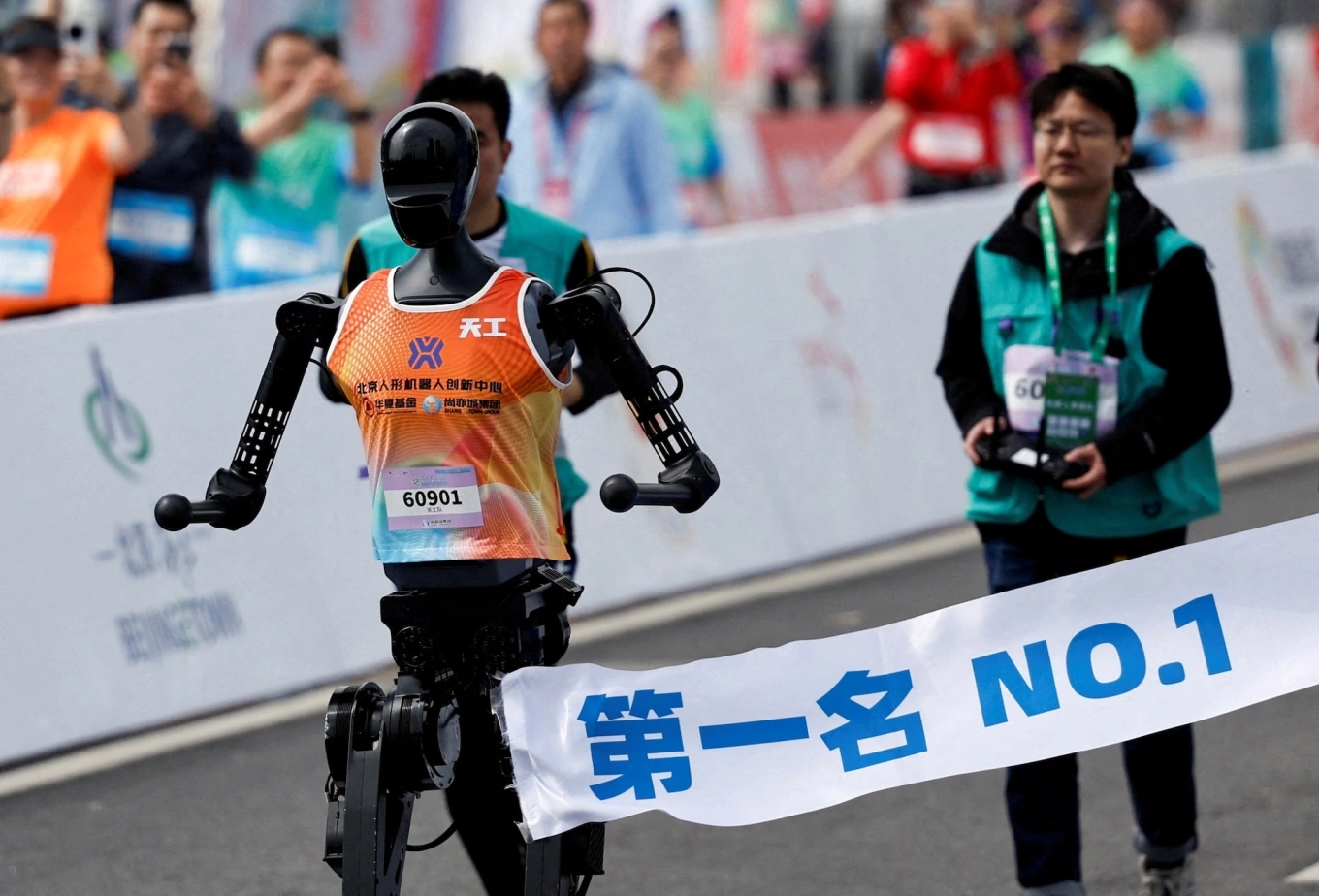 Tiangong Ultra, a humanoid robot, runs across the finish line while securing the first position during the E-Town Humanoid Robot Half Marathon, in Beijing, China, April 19, 2025. Photo by Reuters