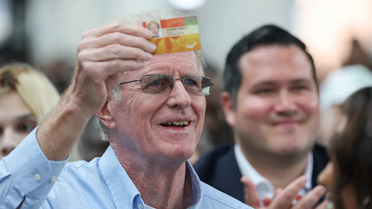 US actor and environmental activist Ed Begley Jr. holds up his senior fare card during the opening for the LAX/Metro Transit Center rail and bus public transportation station at Los Angeles International Airport in Los Angeles, California on June 6, 2025.