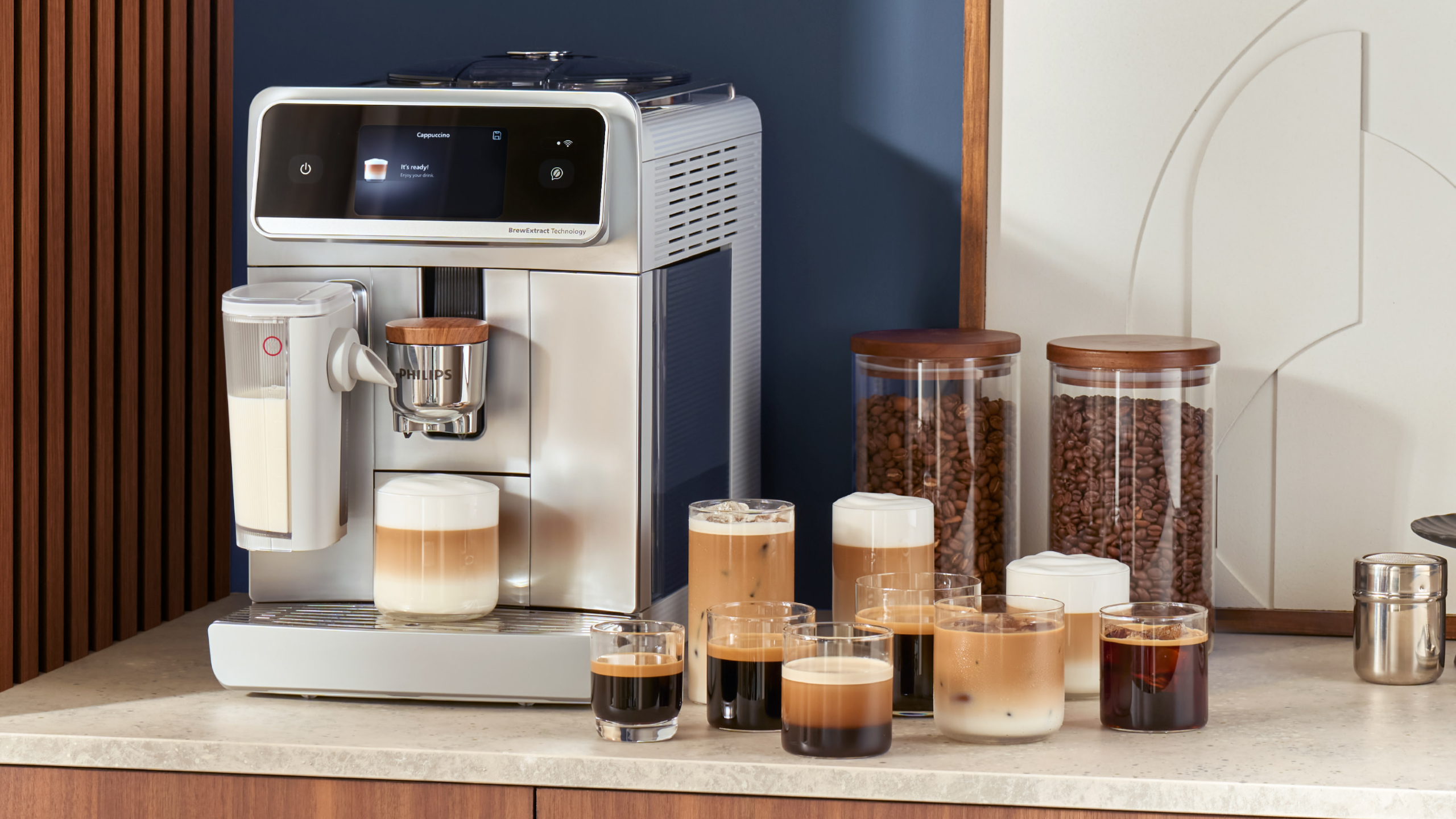 Philips Caf&eacute; Aromis coffee maker on kitchen counter with a variety of coffee drinks