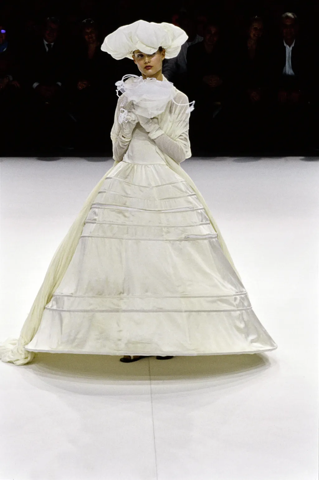 Image may contain Clothing Apparel Fashion Evening Dress Gown Robe Wedding Gown Wedding Dress Hat and Tie