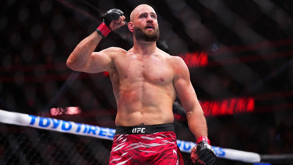 Jiř&iacute; Proch&aacute;zka raises his fist in the air after winning a UFC fight.