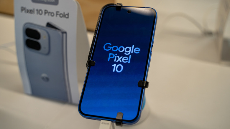 Google Pixel 10 on display before its release date on a wood desk.