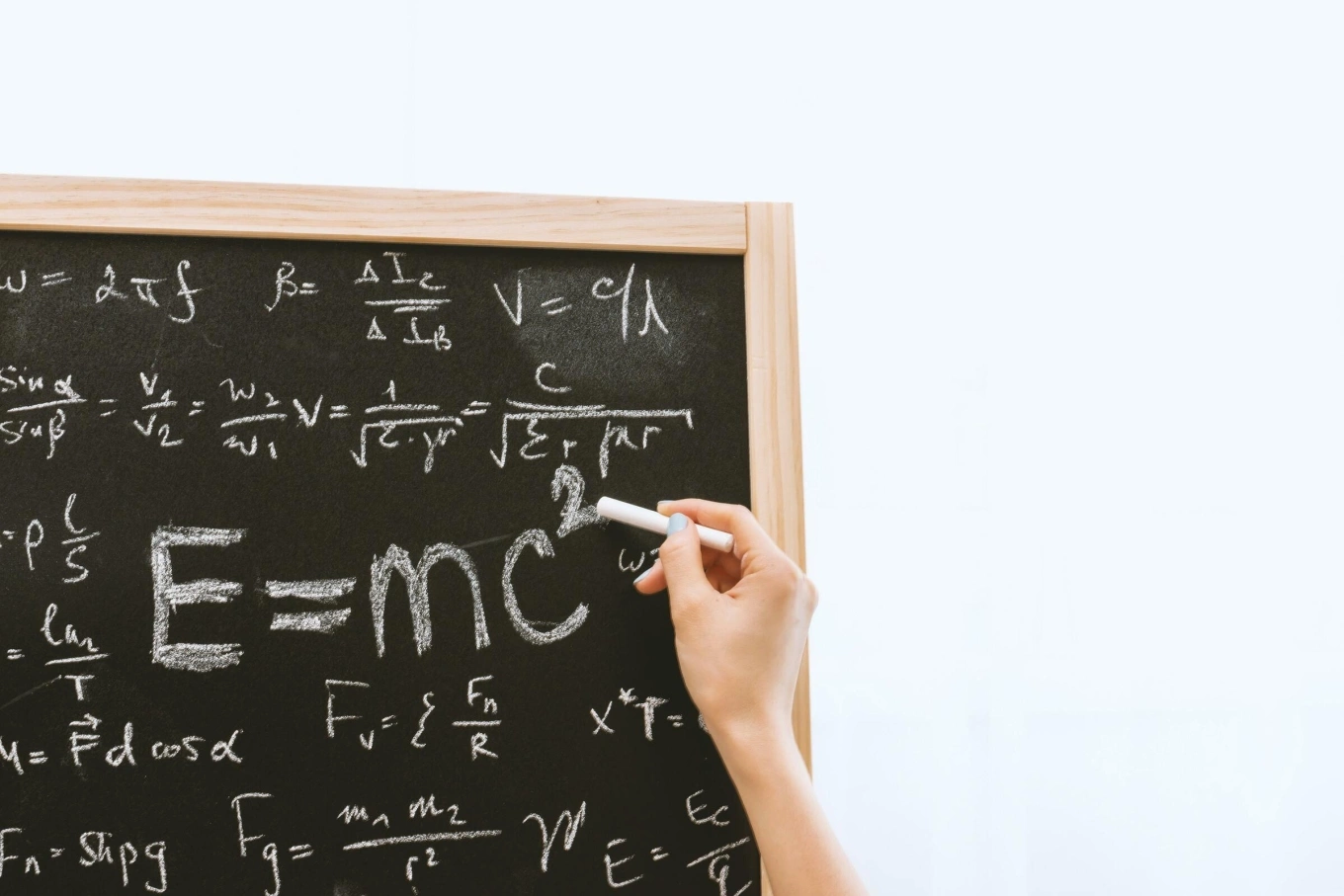 Math problems written on a black board. Photo from Pexels