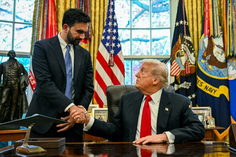 Donald Trump and Zohran Mamdani shake hands.