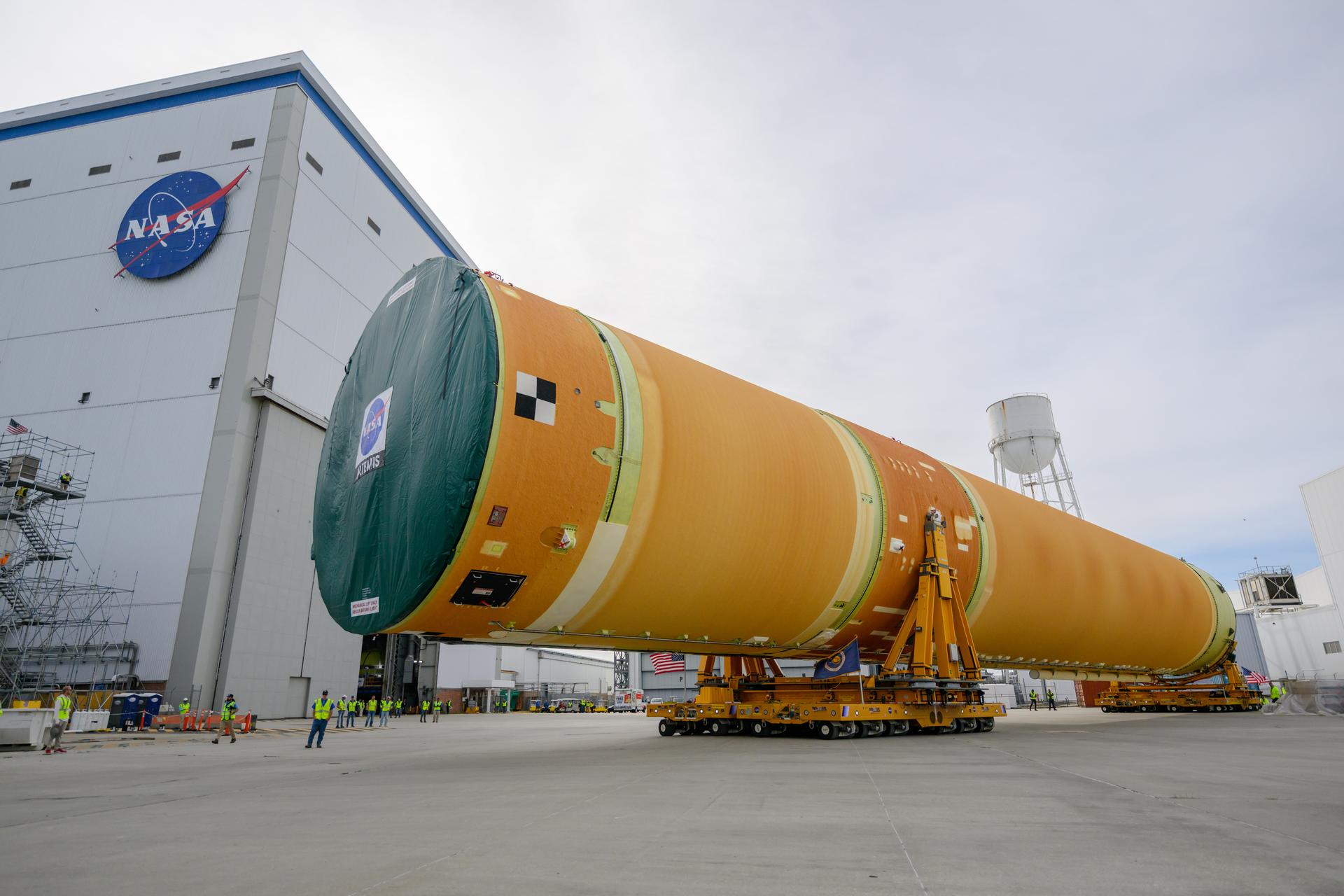 NASA moved the core stage, or the largest section, of the SLS (Space Launch System) rocket that will launch the crewed Artemis III mission in 2027 from the agency’s Michoud Assembly Facility to the agency’s Pegasus barge in New Orleans on April 20. The barge will ferry the top four-fifths – the section containing the liquid hydrogen tank, liquid oxygen tank, intertank, and forward skirt – of the SLS core stage to NASA’s Kennedy Space Center in Florida to complete outfitting and vertical integration.  Teams with NASA and Boeing, the SLS core stage lead contractor, used specialized transporters to guide the top four-fifths from the NASA rocket factory to Pegasus. Prior to the move, technicians added an engine section transportation simulator to the rocket stage for shipment to the Space Coast.  Next year’s Artemis III mission will launch astronauts to Earth’s orbit aboard the Orion spacecraft on top of SLS to test rendezvous and docking capabilities between Orion and commercial spacecraft needed to land Artemis IV astronauts on the Moon in 2028. NASA’s SLS is the only rocket capable of sending Orion, astronauts, and supplies to the Moon in a single launch.   Photo Credit: NASA/Eric Bordelon