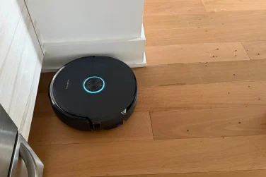 Narwal Flow 2 robot vacuum cleaning hardwood floor near wall