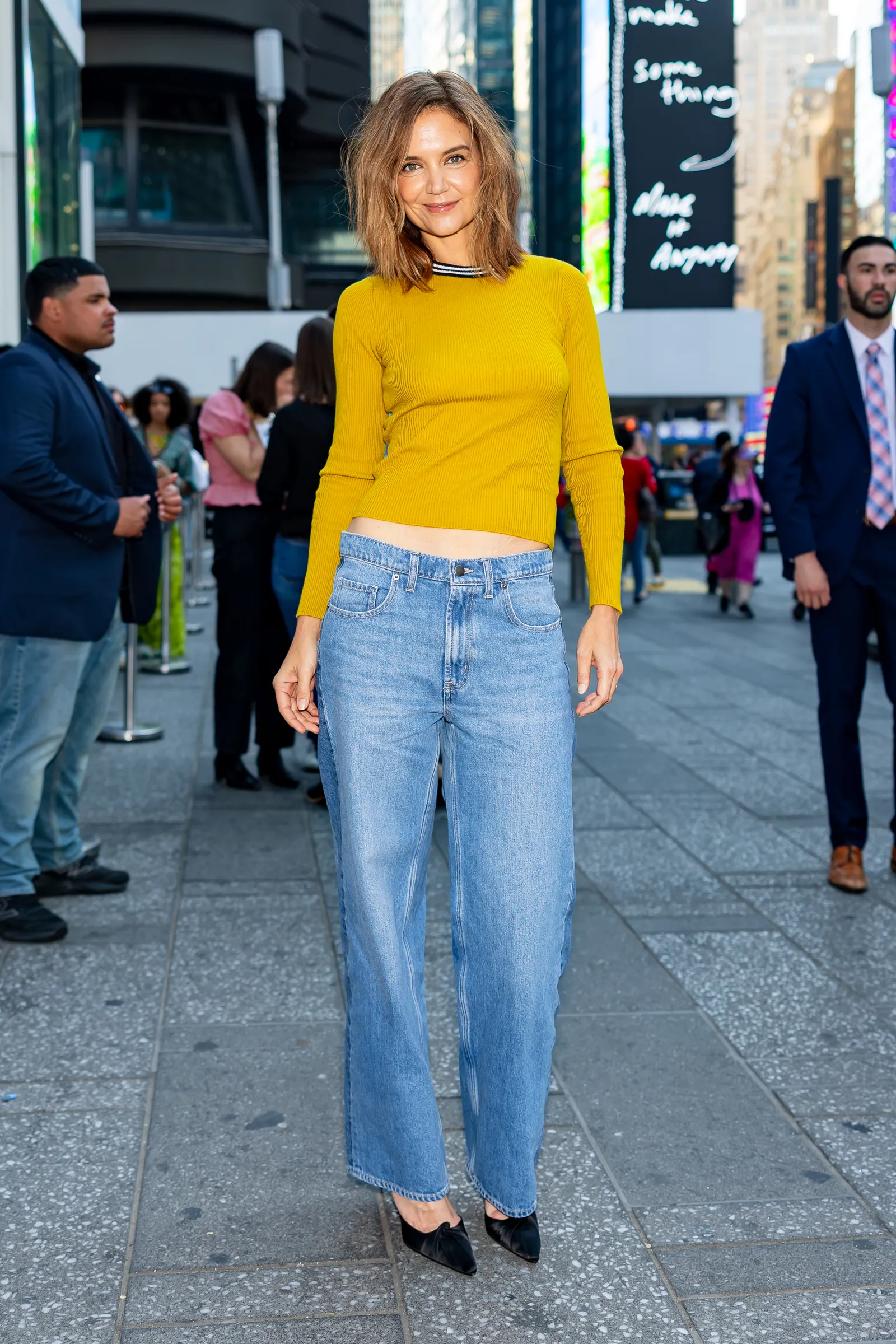 Image may contain Katie Holmes Clothing Jeans Pants Adult Person Coat Formal Wear Suit and Teen