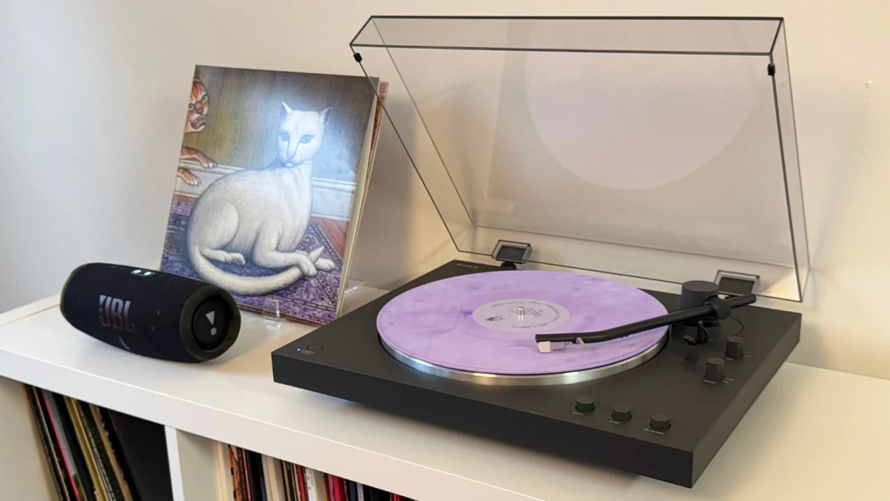 the sony PS-LX3BT next to a mitski vinyl sleeve and a jbl charge 5 speaker