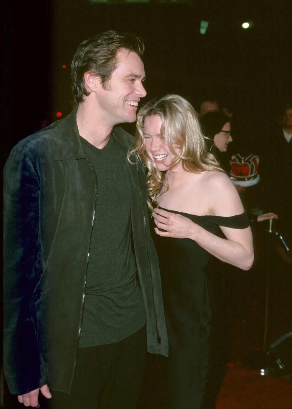 Image may contain Jim Carrey Rene Zellweger Clothing Coat Jacket Blazer Face Head Person Photography and Portrait