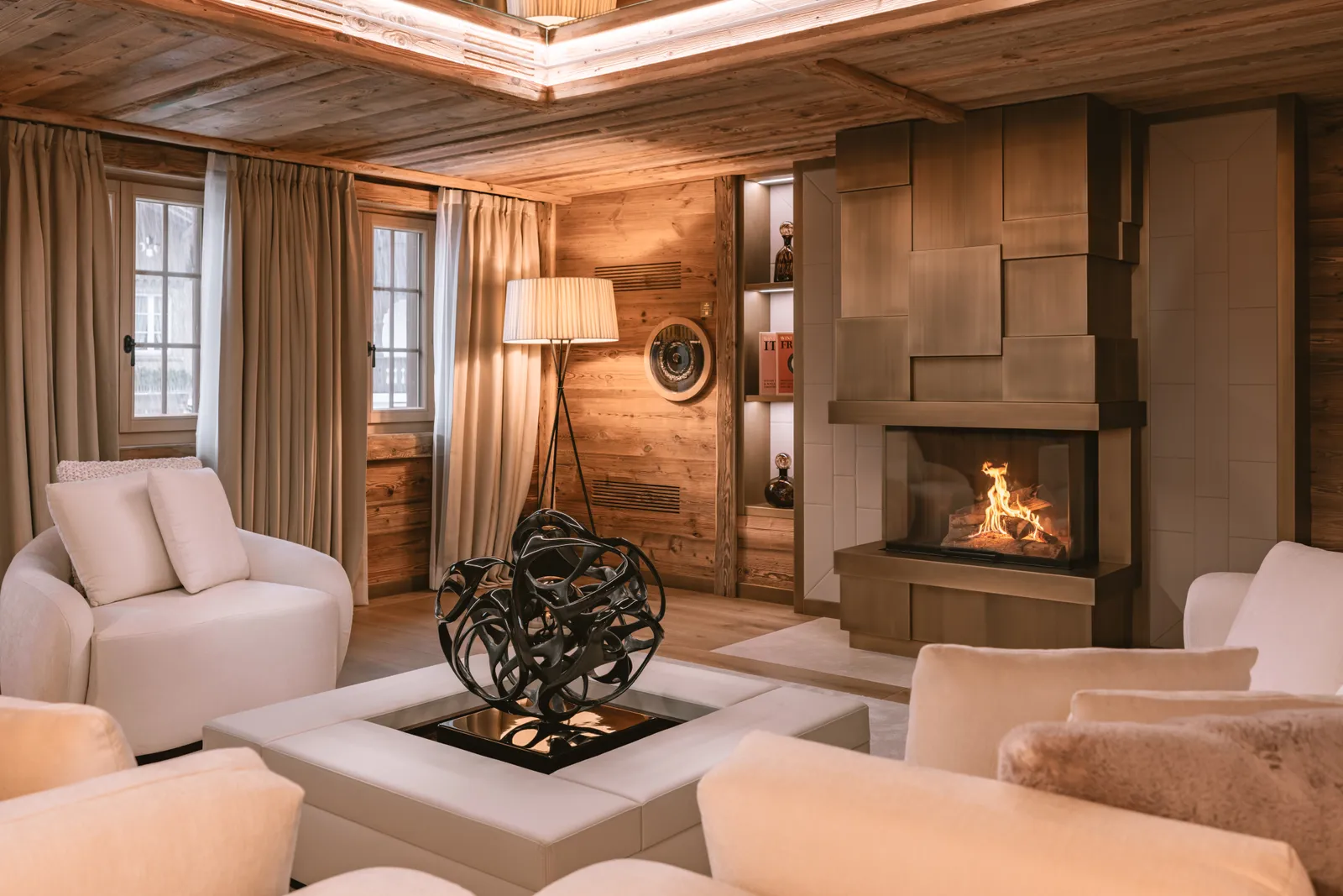Image may contain Indoors Interior Design Wood Panels Lamp and Person