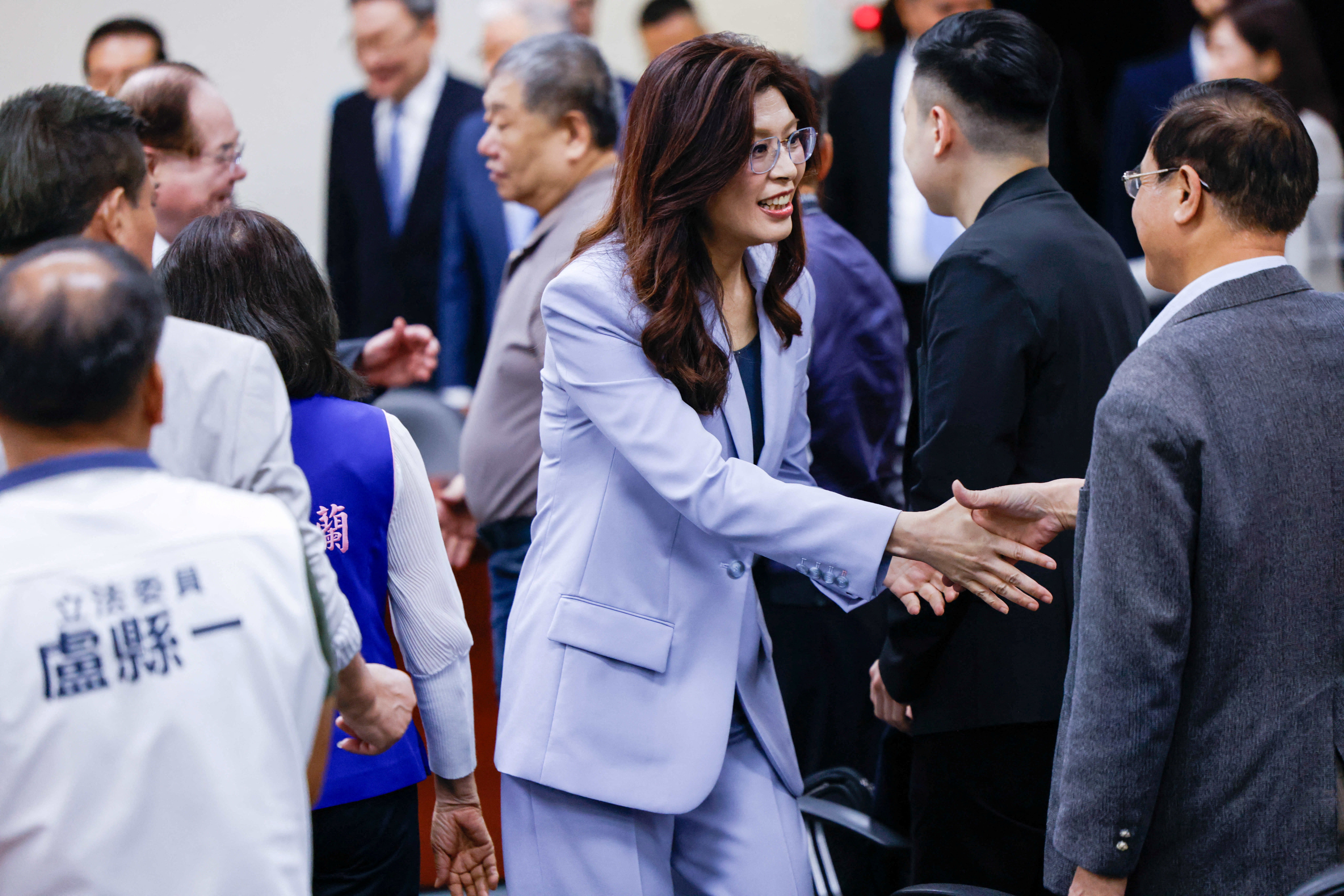 Kuomintang (KMT) chairperson Cheng Li-wun greets other party members before speaking to the media ahead of her trip to China, in Taipei, Taiwan, 7 April 2026