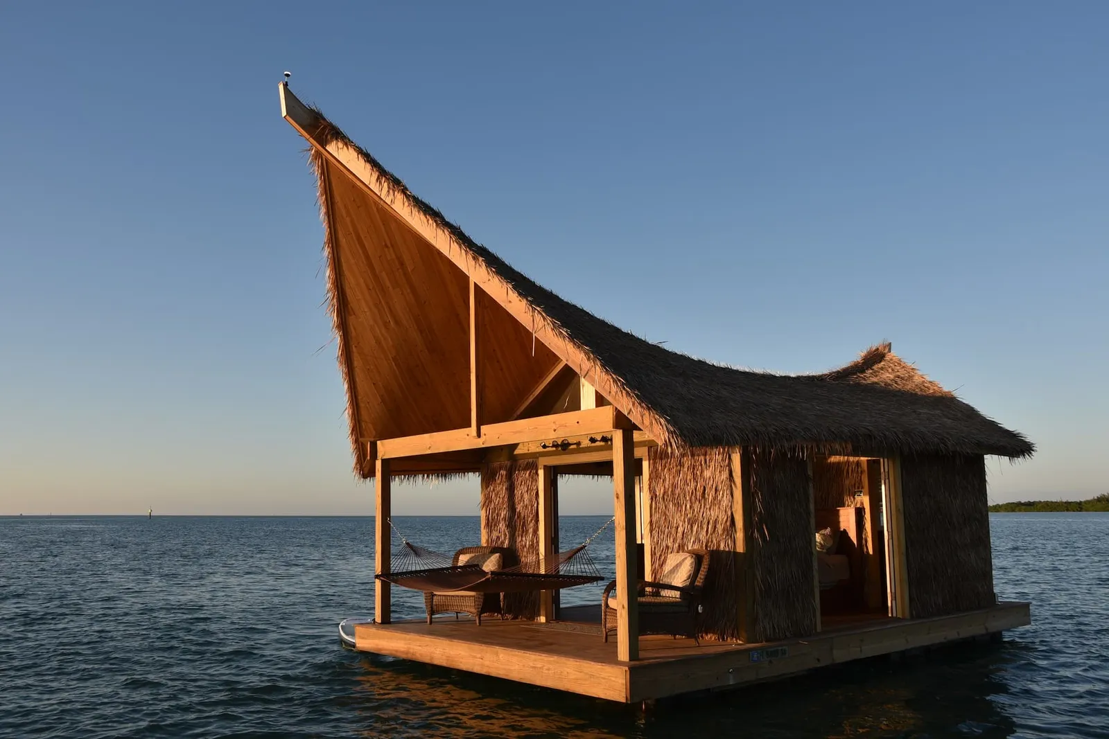 Image may contain Architecture Building Outdoors Shelter Countryside Hut Nature Rural Chair Furniture and Wood