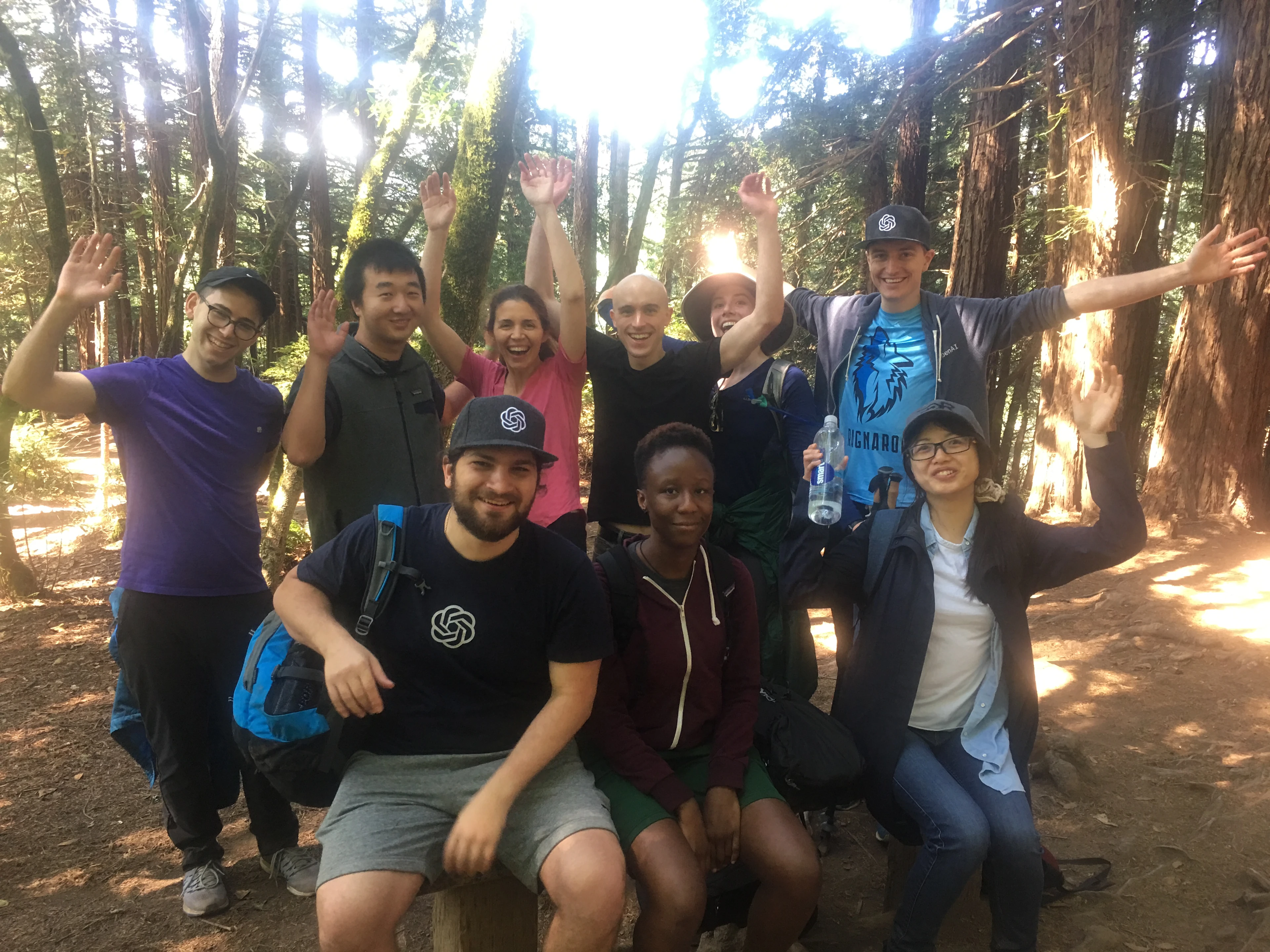 2018 OpenAI Scholars, Fellows, and Interns relax on a group hike